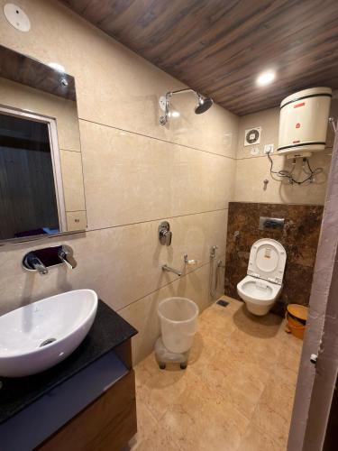 a bathroom with a sink and a toilet at Hotel Avalanche in Shimla