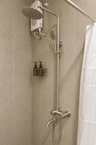 a shower with a shower head in a bathroom at Sansara Maldives - The Untouched South, Easy Access via Sri Lanka in Meedhoo