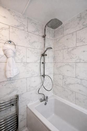 a white bathroom with a shower and a tub at Fully Equipped Homely Heaven in Houghton le Spring
