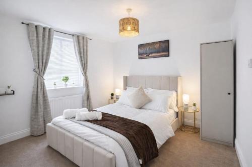 a bedroom with a large white bed and a window at Fully Equipped Homely Heaven in Houghton le Spring