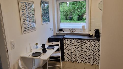 a small kitchen with a sink and a window at Ulli's Oase in Uettingen