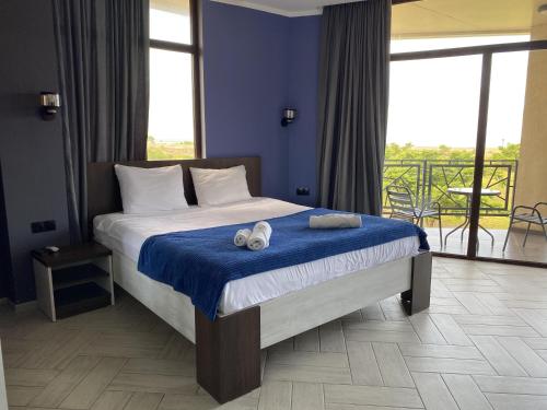 a bedroom with a bed with two towels on it at Hotel AnOrita in Kobuleti