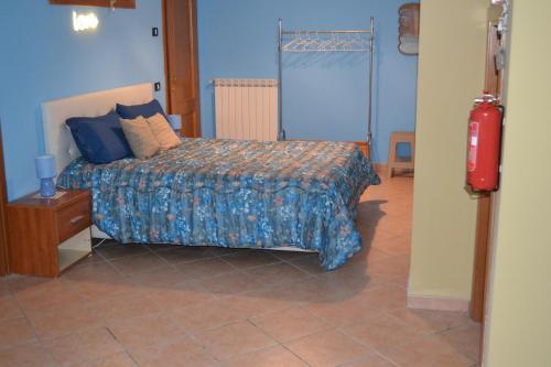 a bedroom with a bed in a blue room at B&B La Casa di Gastone in Mercogliano