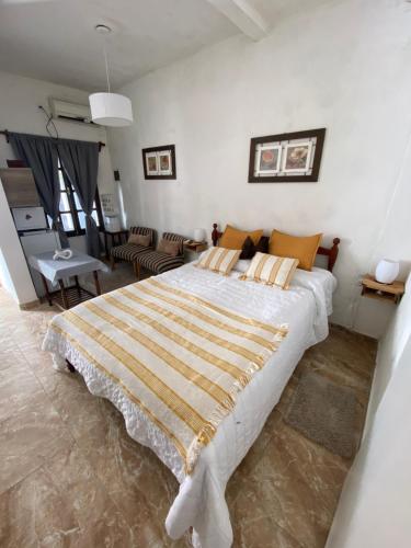 a bedroom with a large bed and a living room at Casita de Norma, Mercedes Corrientes!!! in Mercedes
