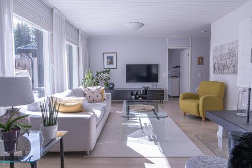 a living room with a couch and a tv at Villa White Star in Rovaniemi