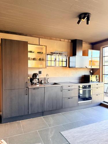 a large kitchen with stainless steel cabinets and appliances at Parkside studio in Hjo