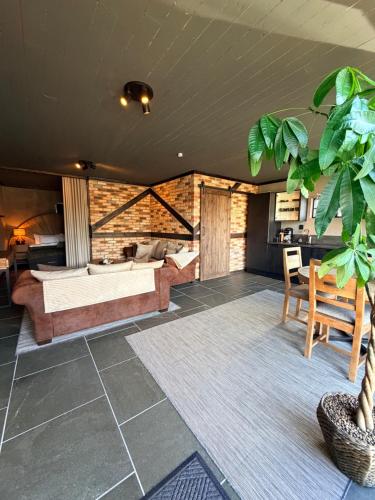 a room with a bed and a couch and a table at Parkside studio in Hjo