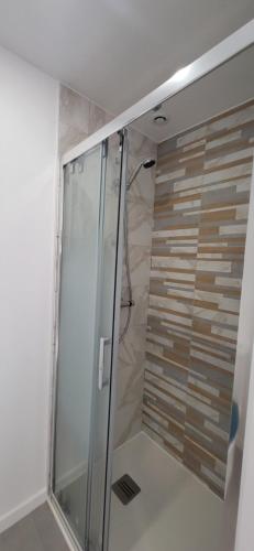 a shower with a glass door in a bathroom at quiet house in Nogent-sur-Eure