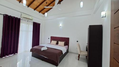 a bedroom with a bed and a chair in it at Haven Stay in Sri Jayewardenepura Kotte