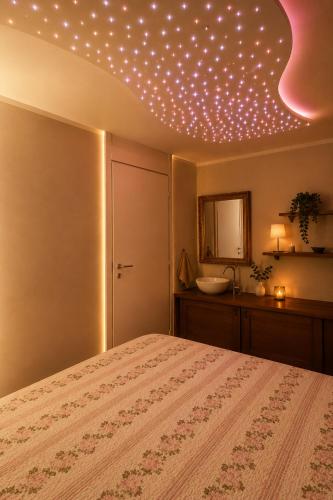 a bedroom with a bed with lights on the ceiling at Spa & Relax in Cairo Montenotte