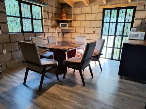 a dining room with a table and chairs at Cabaña Metztli in Amealco