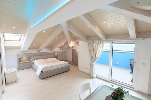 a bedroom with a bed and a view of the ocean at Art Hotel La Perla in Bellaria-Igea Marina