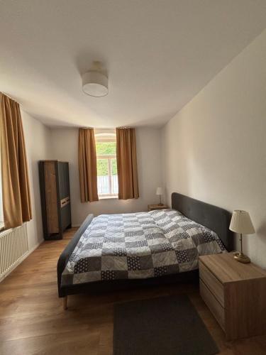 a bedroom with a large bed and a window at Waldvilla in Bad Schandau