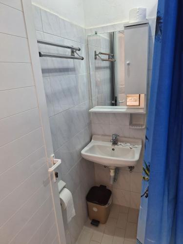 a small bathroom with a sink and a mirror at Vera Studios in Faliraki