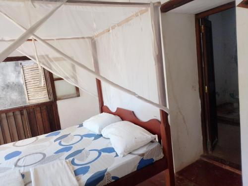 a bed with a canopy in a room at Magram House in Lamu