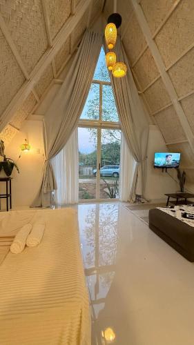 a bedroom with a bed and a large window at Cabin Mattias in Coron