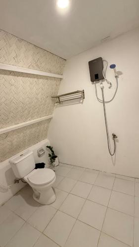a bathroom with a toilet and a shower at Cabin Mattias in Coron