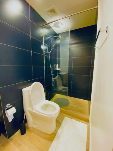 a bathroom with a toilet and a shower at Nairobi Comfort Suites in Nairobi