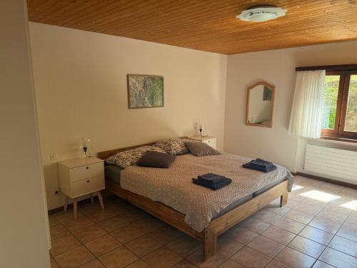 a bedroom with a bed with two towels on it at Appartamenti Posse- Verzasca in Lavertezzo