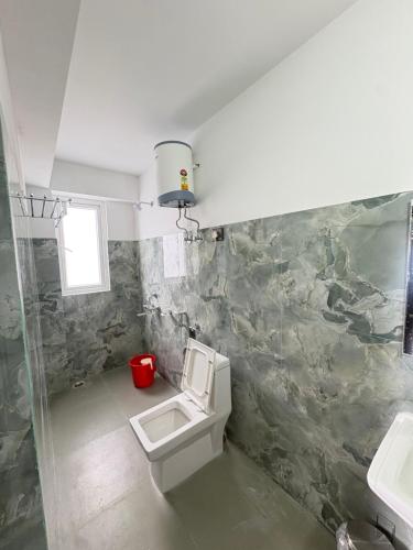 a bathroom with a toilet and a sink at Hotel khangyul in Ravangla