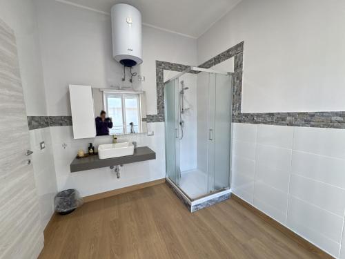 a bathroom with a shower and a sink and a mirror at Zero18 - Pompei Rooms in Scafati