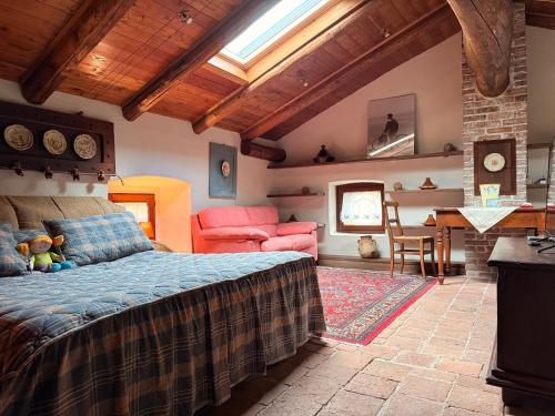 a bedroom with a bed and a table in a room at La casa Arancione in Boves
