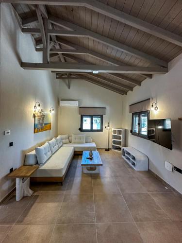 a living room with a couch and a table at THAλEIA Holiday Home in Nea Kallikrateia
