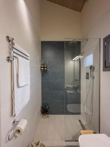 a bathroom with a shower and a toilet and a sink at THAλEIA Holiday Home in Nea Kallikrateia