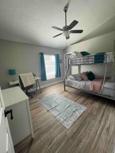 a bedroom with a bed and a ceiling fan at Spacious Home w heated Pool SmartTVs Pool Table in Riverview