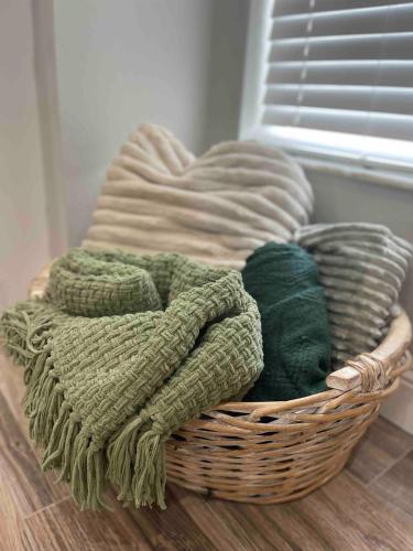 a basket filled with blankets on top of a floor at Spacious Home w heated Pool SmartTVs Pool Table in Riverview
