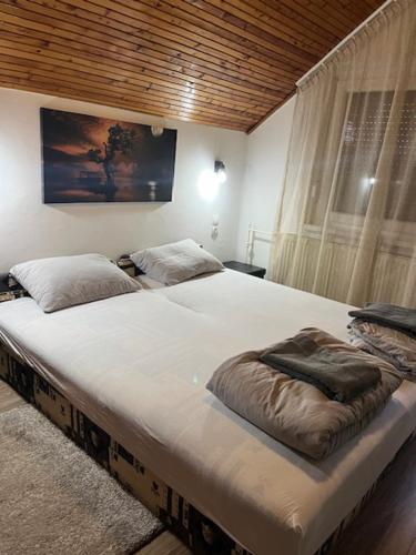a large white bed in a room with at Haraplak in Hajdúszoboszló