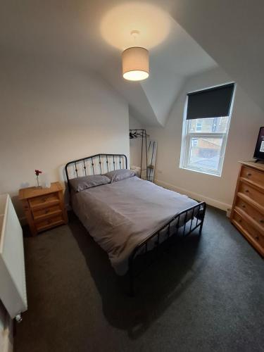 a bedroom with a large bed and a window at Alice House Long stays in Sunderland