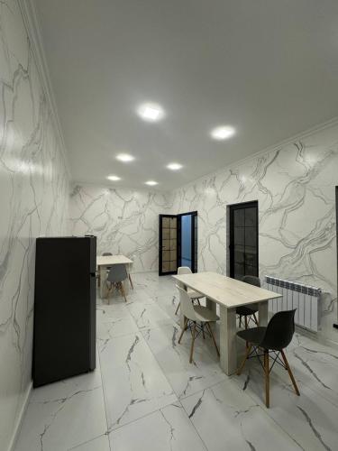 a room with a table and chairs and marble walls at Bank Hotel in Yeghegnadzor