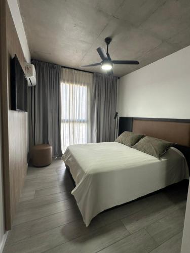a bedroom with a bed and a ceiling fan at Concepto Home in Rafaela