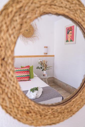 a bedroom with a bed and a mirror at Hotel La Villoría in Medina Sidonia