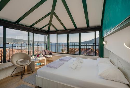 a bedroom with a bed and a view of the ocean at Guesthouse Villa Stari Grad in Herceg-Novi
