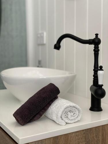 a bathroom counter with a sink and a towel at Coco's Bungalow in Mudgee