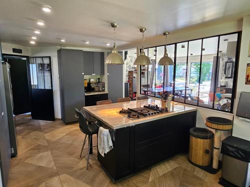 a kitchen with a island in the middle of a room at chambres de La Maillette in Locminé