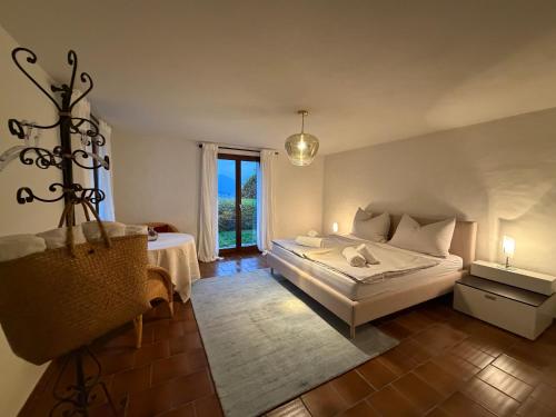 a bedroom with a bed and a large window at Mediterranes Lebensgefühl Tessin in Gerra