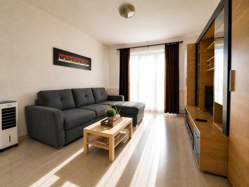 a living room with a couch and a table at Brasov Altipiani Apartments in Braşov