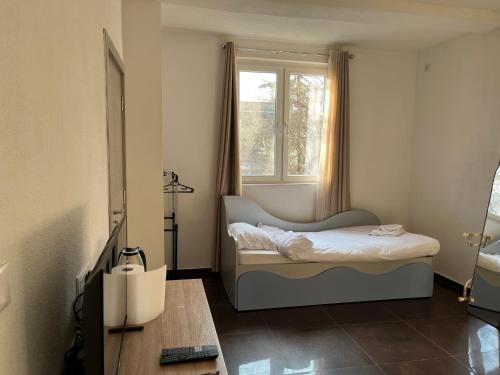 a bedroom with a bed and a window at Center City Stay 2 in Skopje