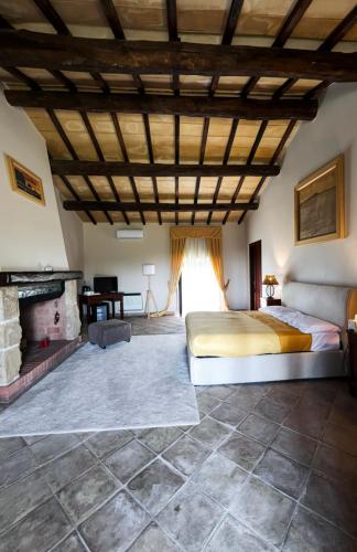 a bedroom with a bed and a fireplace at Agriturismo Cerrosughero in Canino