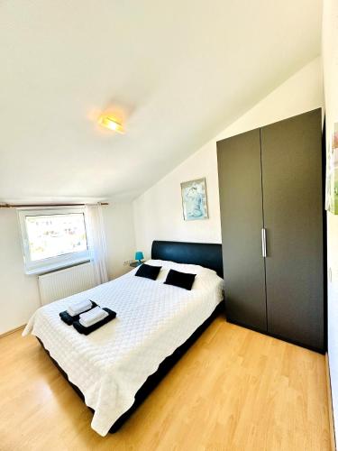 a bedroom with a large bed and a large closet at Maja Apartment 2 in Funtana