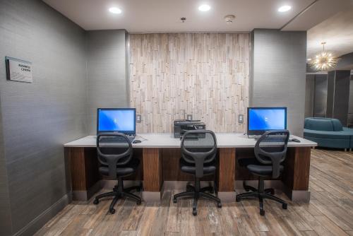 a office with two computers on a desk with chairs at Comfort Inn Largo-Washington DC East in Upper Marlboro