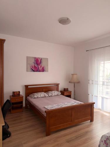 a bedroom with a bed and a large window at Apartment Guberinic in Tivat