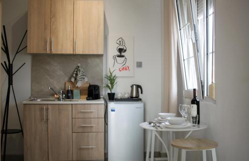 a small kitchen with a refrigerator and a table at Scalo del Mare Apartment in Keramoti