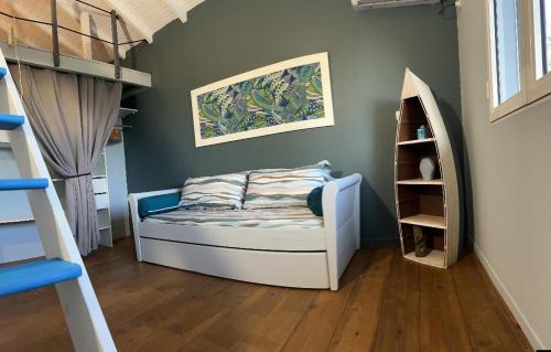 a bedroom with a bed and a book shelf at Villa d'architecte avec piscine in Saint-François