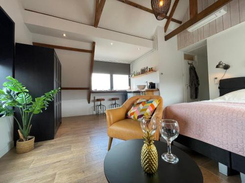 a bedroom with a bed and a table with a chair at Room at the Beach Egmond in Egmond aan Zee