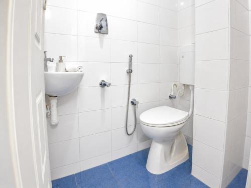 a bathroom with a toilet and a sink at Gardens by Lotels in Madambakkam