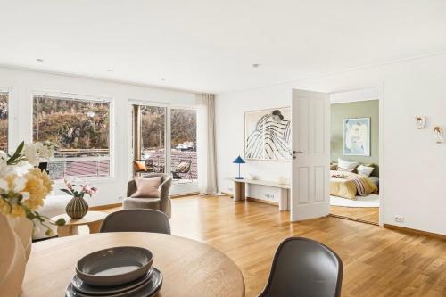 a living room with a table and chairs and a bedroom at The Nordic Escape - Oceanview - Hetlevik in Askøy